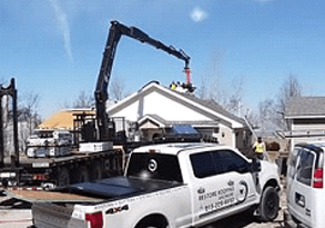 A white truck with a crane on top of it.
